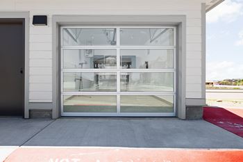 a glass door on a white building with a view of an airport at Upland Flats, Colorado, 80922